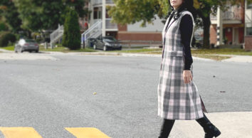 model walking across street in long plaid vest