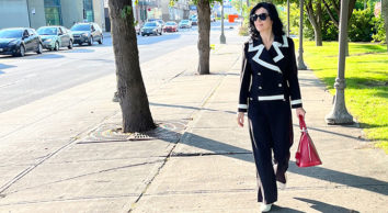 Black and white travel ready jersey pant suit, sunglasses, red bag